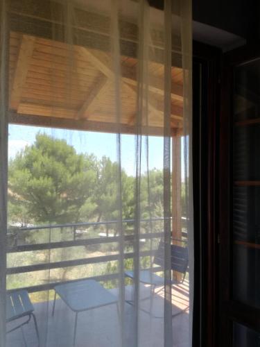 a view from a glass door of a porch with a view at Simo Amour in Lercara Friddi