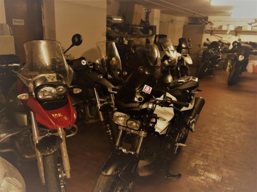 a row of motorcycles parked in a garage at Hotel Galles in Paluzza