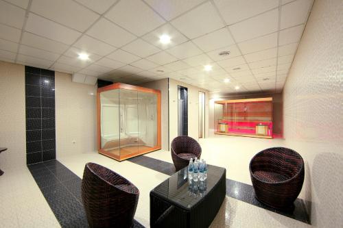 a room with chairs and a table in a room at Damas International Hotel in Bishkek