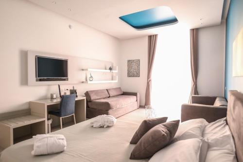 a hotel room with a bed and a living room at Toledo 16 Luxury Suites in Naples