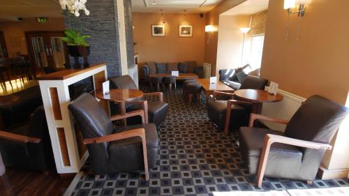 a restaurant with tables and chairs in a room at The Big Blue Hotel - Blackpool Pleasure Beach in Blackpool
