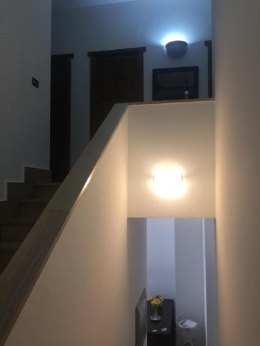 a hallway with a staircase with a light on it at A casa di Gio in Lecce