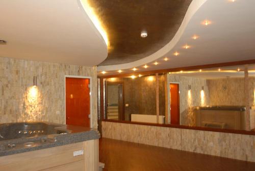 a bathroom with a sink and a large mirror at Hotel Skarpa in Sejny