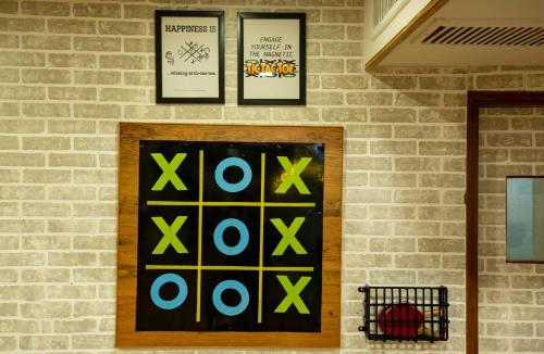 a brick wall with four xoxo signs on it at GANGA KINARE- A Riverside Boutique Resort, Rishikesh in Rishīkesh