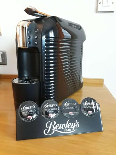 a coffee maker sitting on top of a table at Westgrove Hotel in Clane