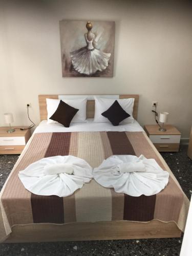 a bedroom with a bed with two towels on it at Periklis House in Nea Kalikratia