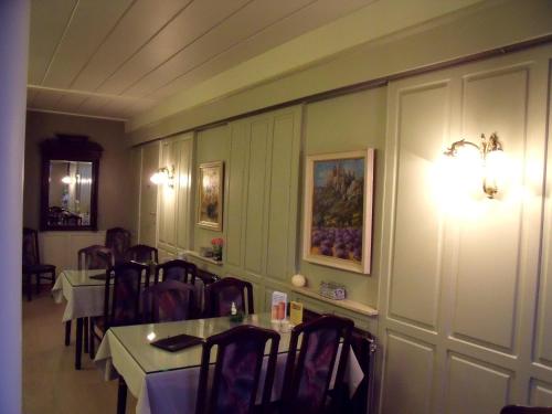 a dining room with a table and chairs at Hotel Plaza in Lommel