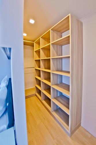 a walk in closet with wooden shelves at Hotel Amfora in St. St. Constantine and Helena