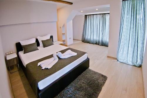 a bedroom with a large bed with towels on it at Hotel Amfora in St. St. Constantine and Helena