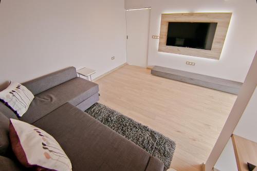 a living room with a couch and a flat screen tv at Hotel Amfora in St. St. Constantine and Helena