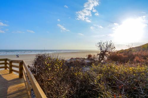 a sandy beach with a wooden boardwalk and the ocean at Mariner's Watch 4236 in Kiawah Island