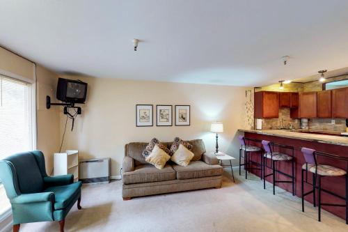 a living room with a couch and a kitchen at North #405 in Girdwood