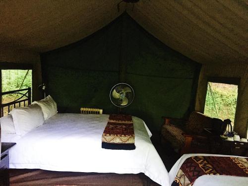 a bedroom with a large bed in a tent at Phophonyane Falls Ecolodge in Piggs Peak