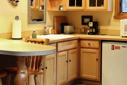 a kitchen with a sink and a counter top at Crow Creek in Girdwood