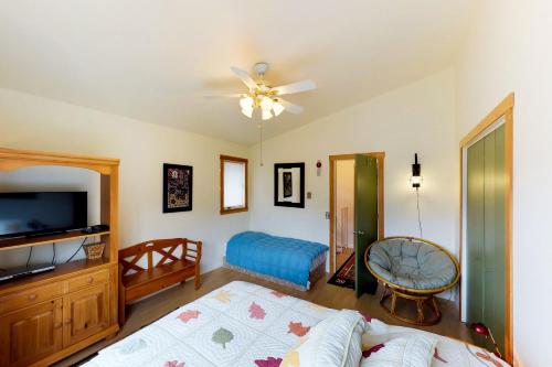 a bedroom with a bed and a flat screen tv at Brighton Condo #208 in Girdwood