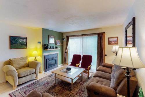 a living room with a couch and chairs and a table at Brighton Condo #208 in Girdwood