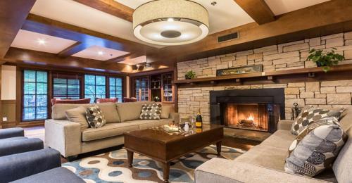 a living room with couches and a fireplace at Château Beauvallon in Mont-Tremblant