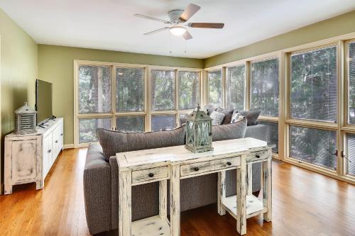 a living room with a couch and a ceiling fan at Baywood Luxury in Seabrook Island
