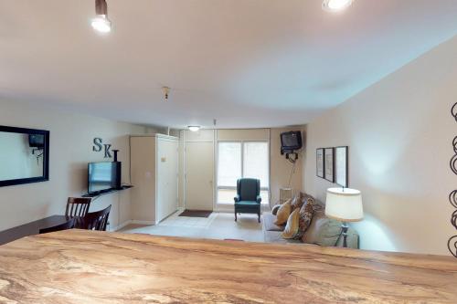 a living room with a large wooden table at North #405 in Girdwood