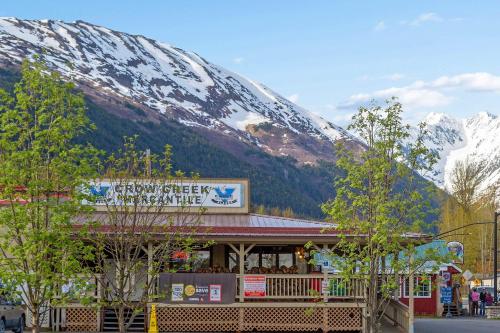 a restaurant with a snow covered mountain in the background at Brighton #108 in Girdwood
