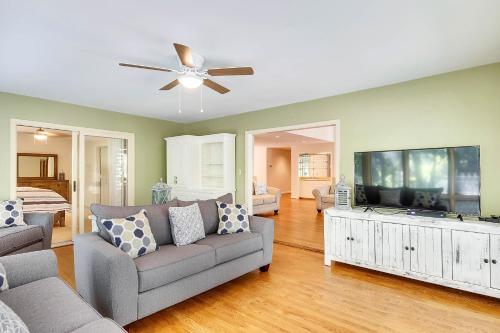 a living room with a couch and a flat screen tv at Baywood Luxury in Seabrook Island