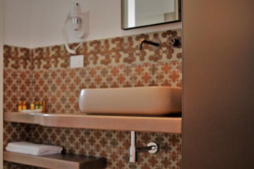 a bathroom with a sink and a mirror at Masseria Torrepietra in Monopoli