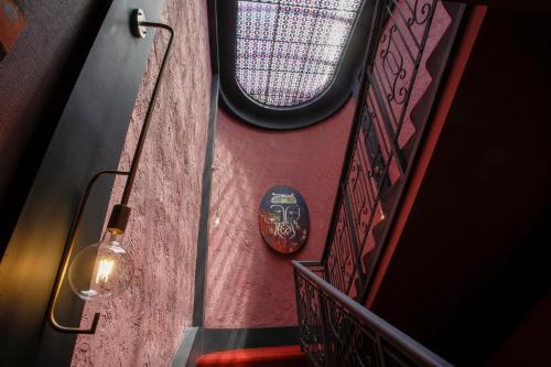 a room with a staircase with a mask on the wall at King Gorgasali in Tbilisi City