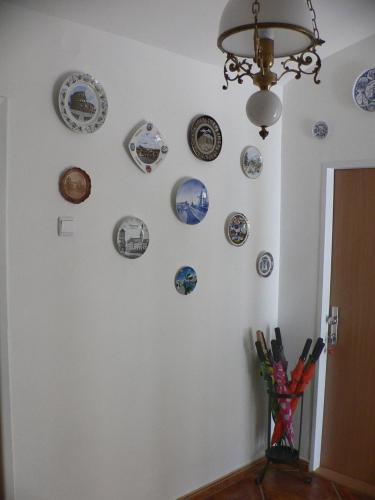 a wall with plates on a white wall at Penzion Speller in Vysoký Újezd