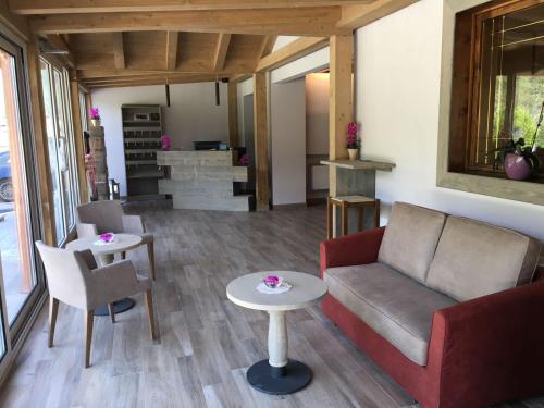 a living room with a couch and a table at Albergo Ristorante Cacciatori in Auronzo di Cadore