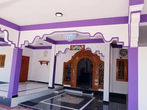 an entrance to a house with purple and white walls at SNP Star Guest House in Trincomalee
