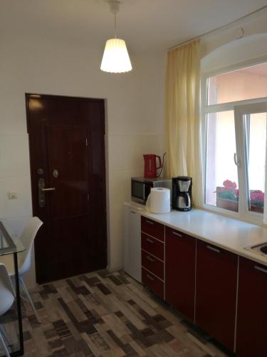 a kitchen with a counter and a window and a sink at Union Square Apartment 2 by NUX in Cluj-Napoca