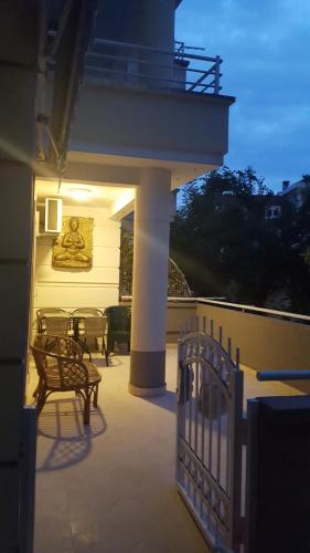 a porch with a fence and a bench on a house at Apartman Muric in Rafailovici