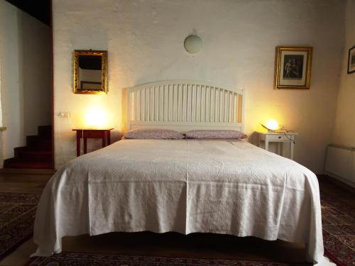 a bedroom with a large bed with a white bedspread at Antico Borgo Camporeso in Galbiate