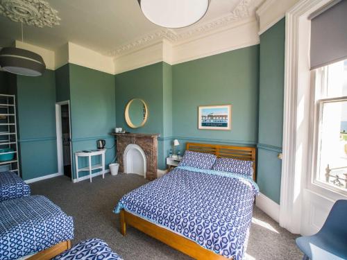 a bedroom with two beds and a fireplace at Westward Ho Hotel in Folkestone