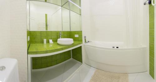 a white bathroom with a sink and a toilet at Basseynaya Apart Hotel in Kyiv