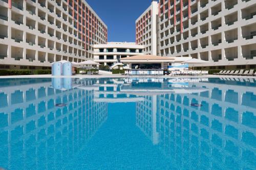 a large swimming pool in front of two buildings at Be Live Family Palmeiras Village All-Inclusive 24H in Armação de Pêra