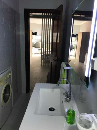 a bathroom with a sink and a washing machine at STUDIO'S HOUSE in Funchal