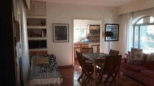 a kitchen and dining room with a table and chairs at Sol Invictus Est in Serranova