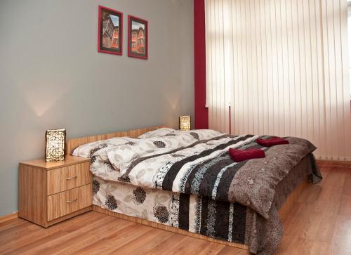 a bedroom with a bed and a wooden floor at Hostel Mostel Hub Rooms and Apartments in Sofia