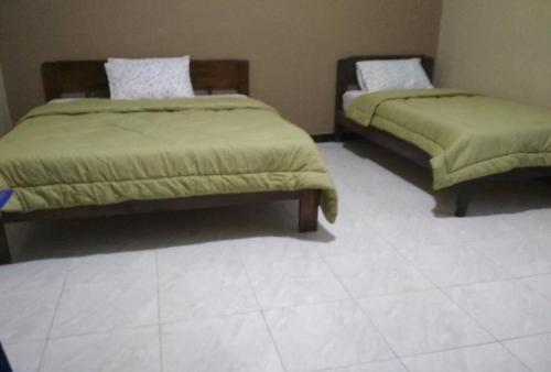 En eller flere senge i et værelse på Cinnamon Guest House