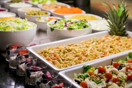 a buffet filled with different types of food in trays at Font D'Argent Canillo in Canillo