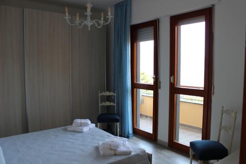 a bedroom with a bed with two towels on it at Seaview Apartment Monterosso, Cinque Terre in Monterosso al Mare
