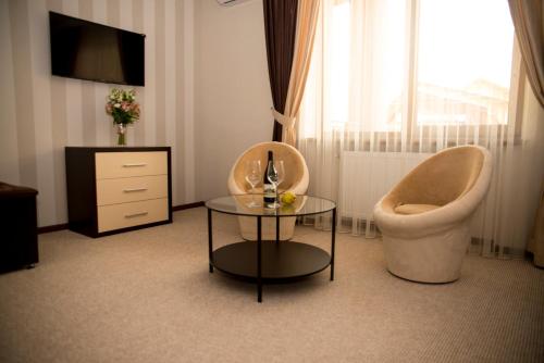 a living room with a chair and a table at Adele in Mizhhirʼʼya
