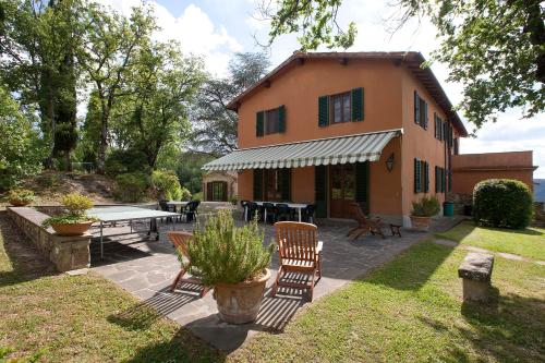 a house with a ping pong table in front of it at Podere Capitignano in Borgo San Lorenzo