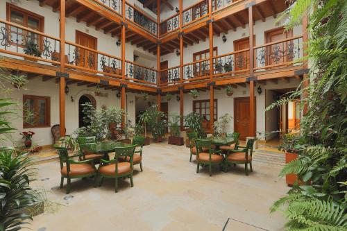 a patio with tables and chairs in a building at Hotel Santa Lucia Boutique Spa in Bogotá