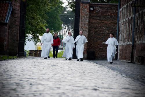 a group of priests walking down a street at B&B Carpe Diem in Westerlo