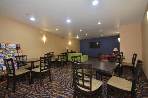 a restaurant with tables and chairs in a room at Ramada by Wyndham Santa Fe in Santa Fe