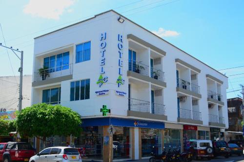 a white building with a sign on it on a street at Hotel Aguazul Plaza Centro in Aguazul