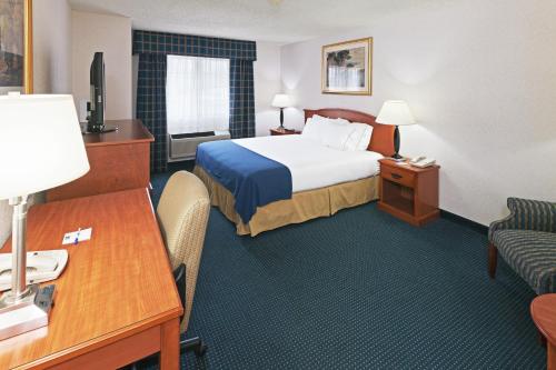 a hotel room with a bed and a desk at Ramada by Wyndham Santa Fe in Santa Fe