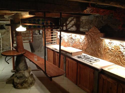 a kitchen with a stove and a counter top at B&B Ca Dei Lenzotti in Riolunato
